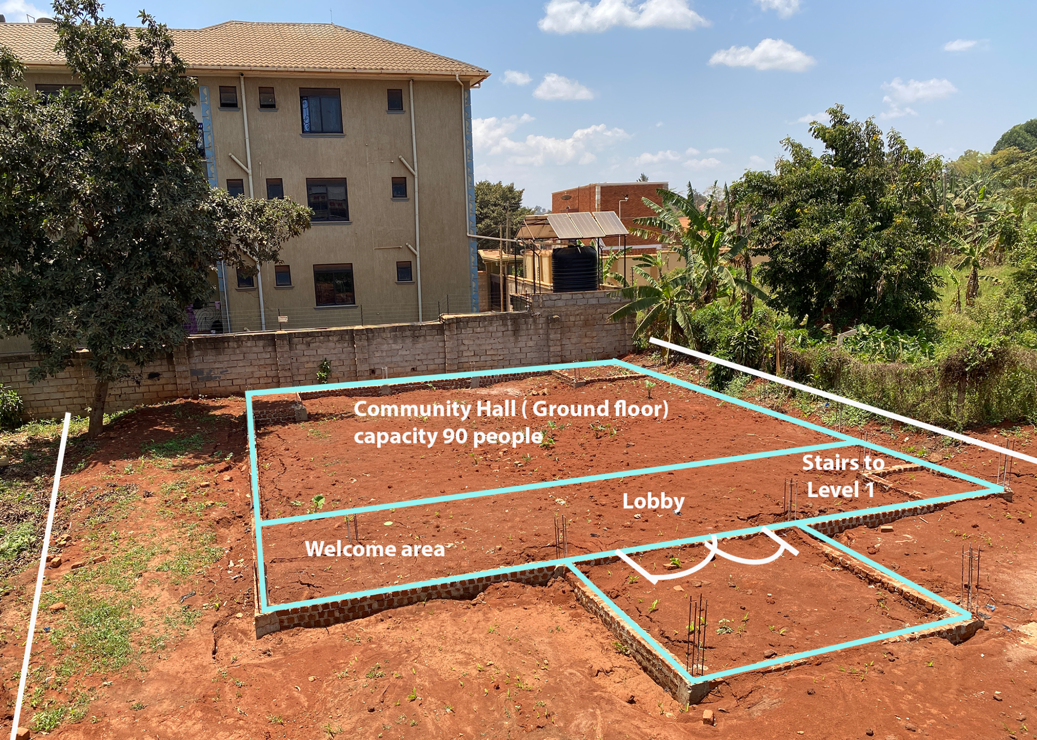 The Love in Action building foundation, with blue lines marking the proposed community hall, lobby, and stairs.