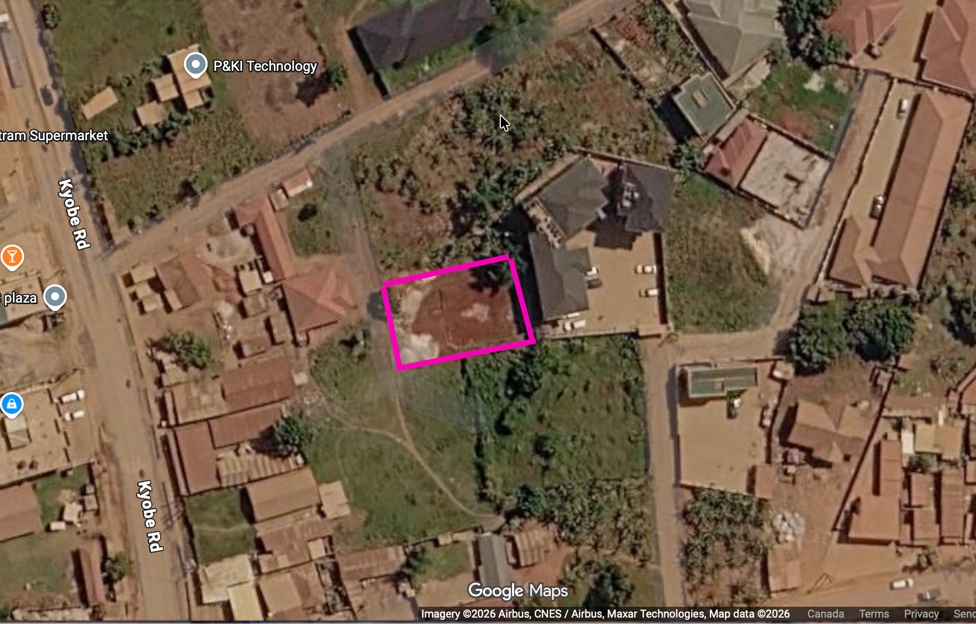 Google Maps satellite view of the project site in Bbuto, Uganda, outlined in pink near Kyobe Road.